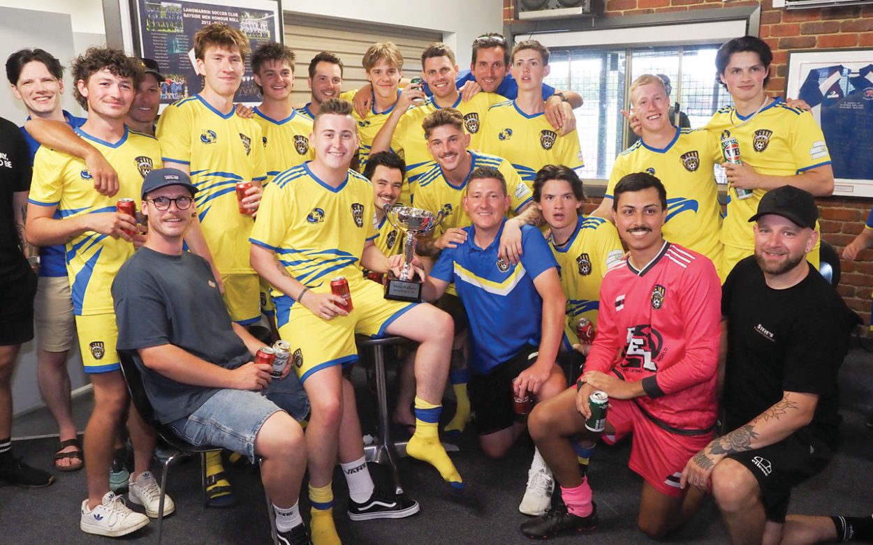 Still at the helm: Somerville Eagles head coach Mark Larner (kneeling, blue shirt) celebrates with his squad after winning the 2024 Steve Wallace Plate back in January. Picture: Darryl Kennedy