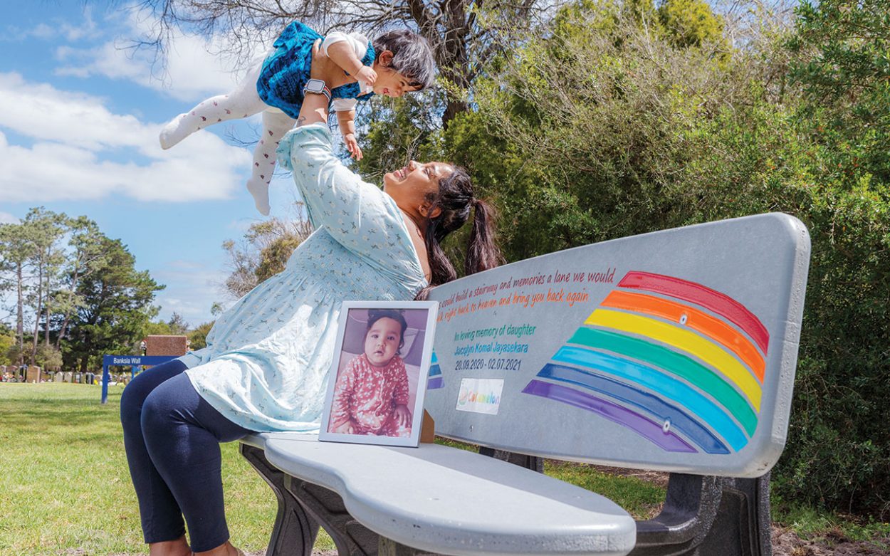 JANELLE Giri with a photo of her nine-month-old daughter Jacqlyn whose memory is honoured in a rainbow bench at Mornington Cemetery. Picture: Gary Sissons