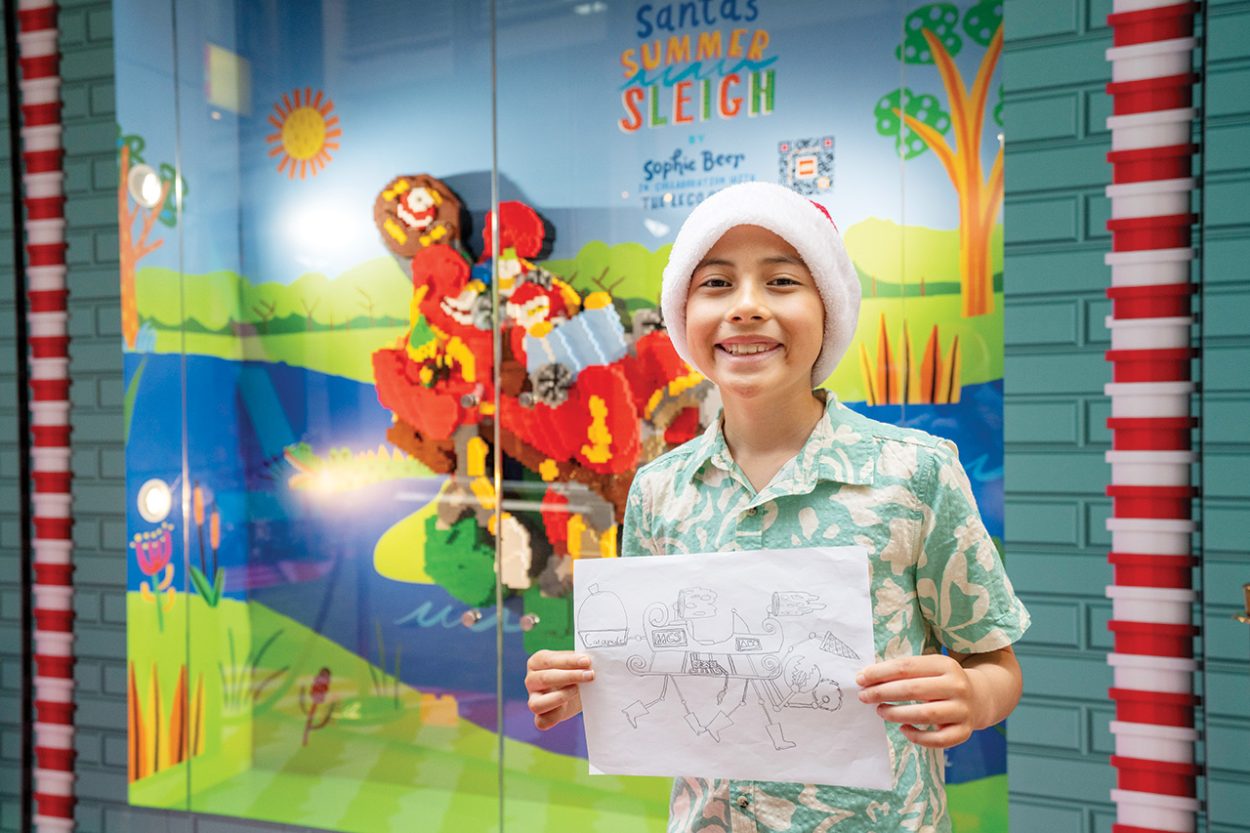 APOLOSI Fosita celebrates his Lego creation at Pitt Street Mall in Sydney. Picture: Supplied